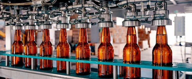 Drink bottling facility with precision-coated mechanisms