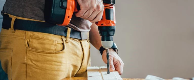 A man using a consumer grade power drill